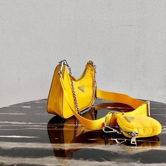 65324ef2cb3fd.jpg Replica Prada 1BH204 Prada Re-Edition 2005 Nylon Bag Yellow - Image 1